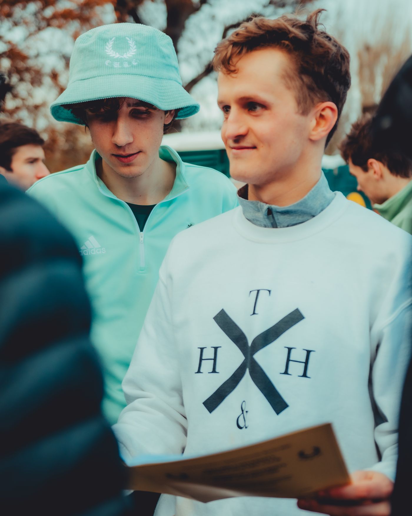 A Thames Hare & Hounds official in a club sweatshirt with the race paperwork, 2025