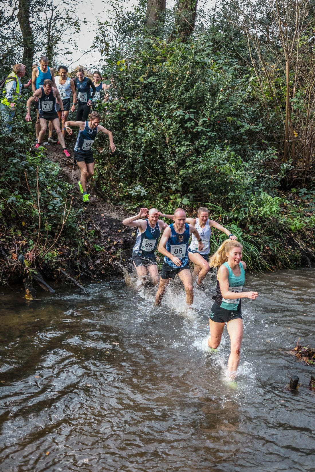 Old Blues’ runners crossing Beverley Brook in a line