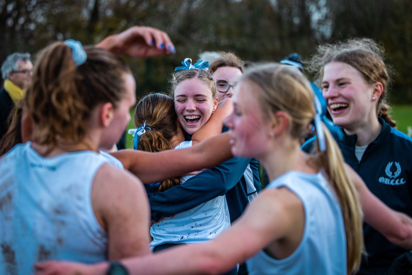 Oxford Ladies’ runners hug and laugh together after the race.